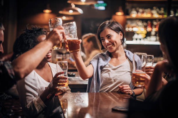 istock Happy friends in a bar 1202339733