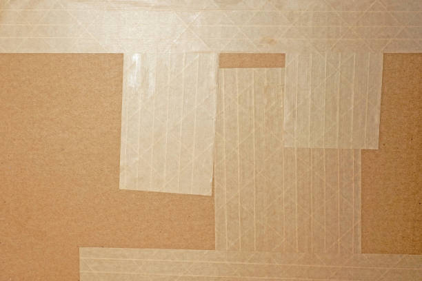 istock Texture of a cardboard box glued with reinforced tape, package 1202340377