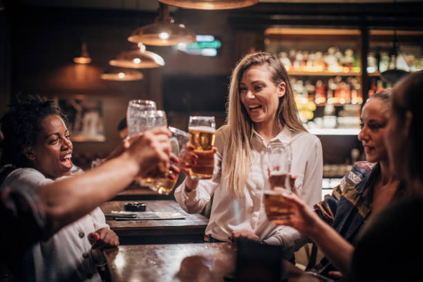 istock Friends having fun drinking beer in a bar 1202341784