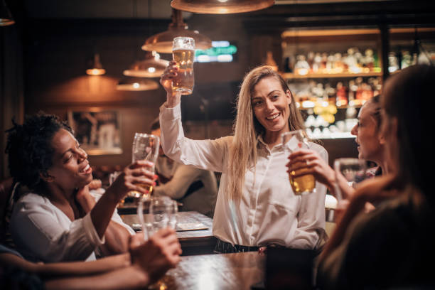 istock Friends drinking beer together in a bar 1202342606