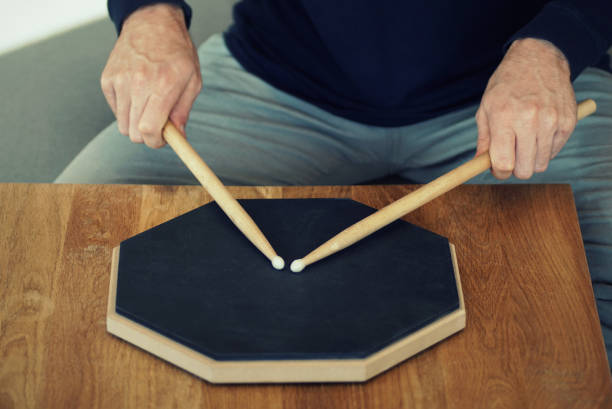 istock Man drumming on a practice pad at home 1202342613