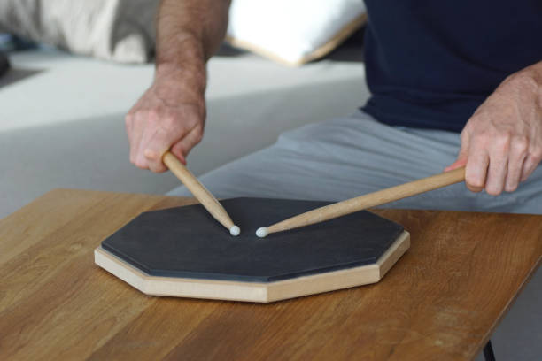 istock male person drumming on a practice pad at home on the sofa 1202342890