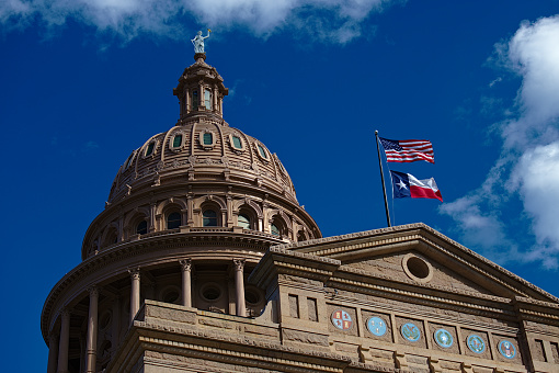 The pink marble granite Texas Capitol building is located at the end of Congress Avenue in downtown Austin, Texas.