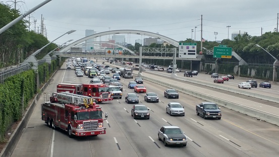 Following a car wreck, emergency services blocks several lanes of traffic on Highway 59 in central Houston, Texas.