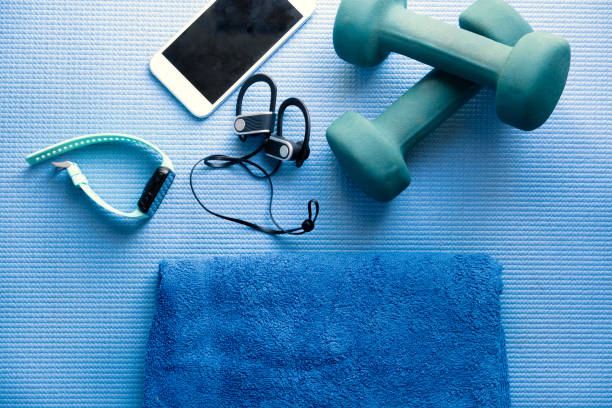 istock fitness equipment and electronics on a blue yoga mat 1202345734