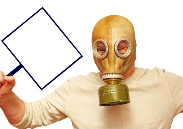 istock Stop Virus concept. Man in gas mask showing placard with empty space isolated on white. 1202346880