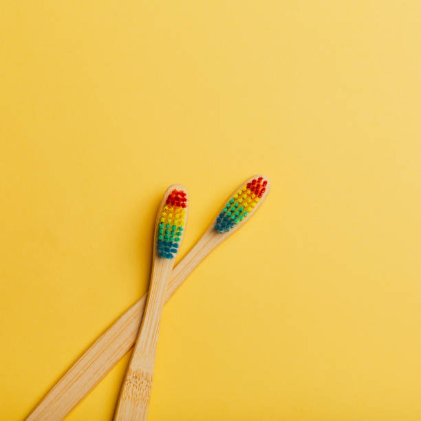 bambusowa tęczowa szczoteczka do zębów na kolorowym tle. - toothbrush dental hygiene dental equipment rainbow zdjęcia i obrazy z banku zdjęć