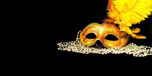 istock Golden Carnival mask on black background with silver beads. Mardi Gras concept. Copy space 1202347346