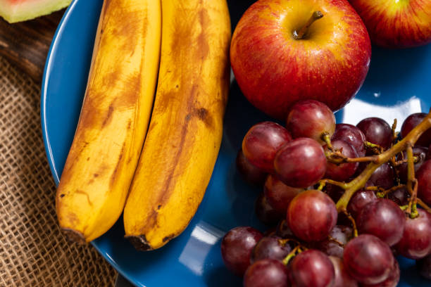 istock assorted fresh fruits on plate on wooden table 1202347629