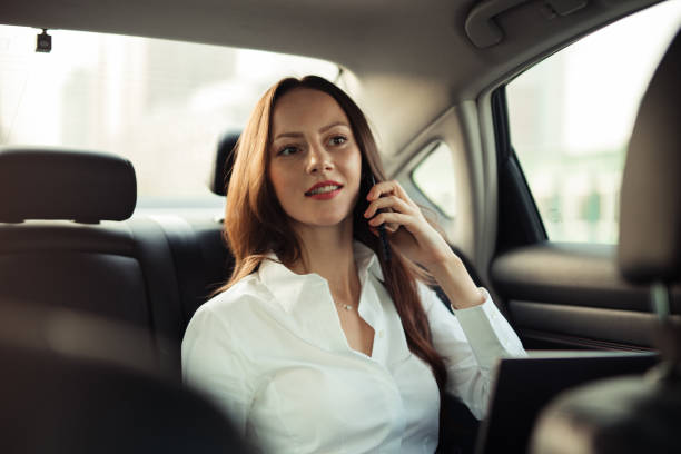 istock Businesswoman using smart phone in a car 1202348527