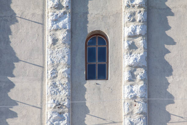 oval window in church tower photo taken on shinny day