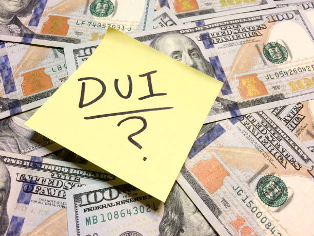 American cash money and yellow post it note with text DUI and question mark American cash money and yellow post it note with text DUI and question mark in black color aerial view philadelphia federal reserve stock pictures, royalty-free photos & images