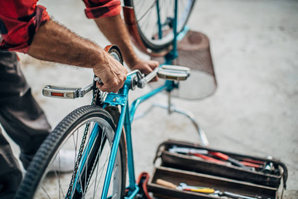 istock Mature man repairing bicycle 1202350355