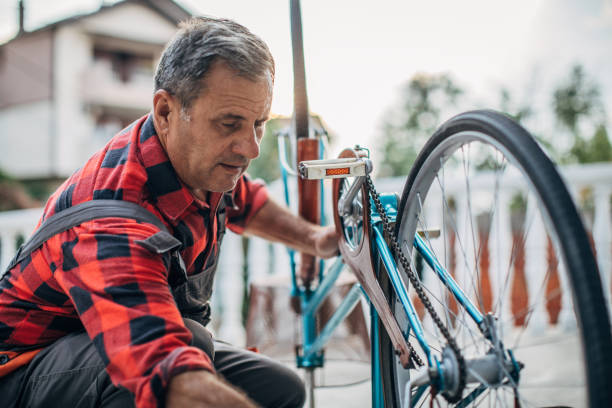 istock Man repairing bicycle in front yard 1202350457
