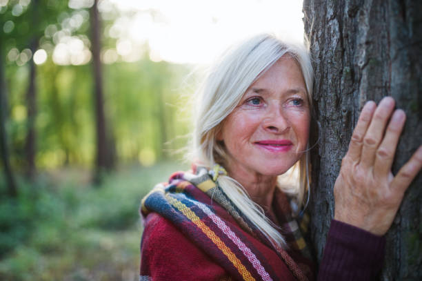 istock Senior woman on a walk in an autumn forest. 1202351272