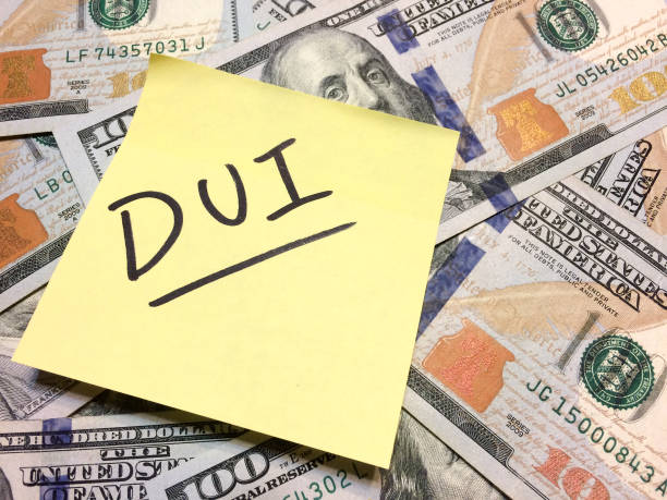 American cash money and yellow post it note with text DUI American cash money and yellow post it note with text DUI in black color aerial view philadelphia federal reserve stock pictures, royalty-free photos & images