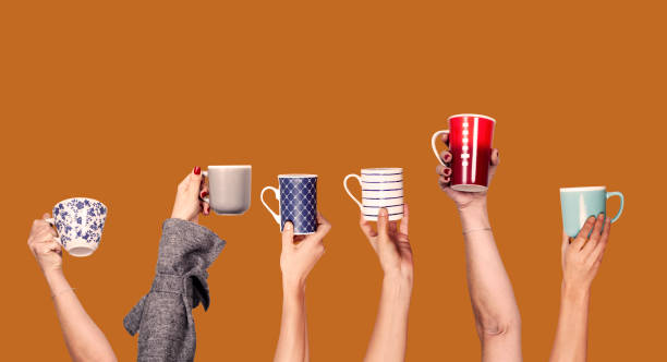 istock many hands up and holding cups of coffee 1202351406