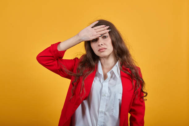 istock Sickness woman in shirt and jacket keeping hand on head, having temperature 1202351492