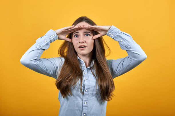 istock Caucasian lady keeping palms on forehead, looking into distance. 1202351518