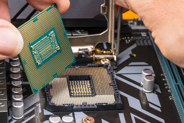 computer processor maintenance detail. hands installing a microprocessor chip - service electronics industry circuit board capacitor imagens e fotografias de stock