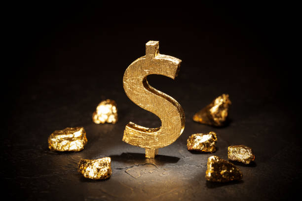 istock Gold dollar sign and gold nuggets on black background 1202354568