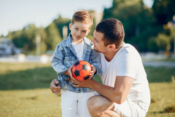 istock Cute family playing in a summer park 1202355799