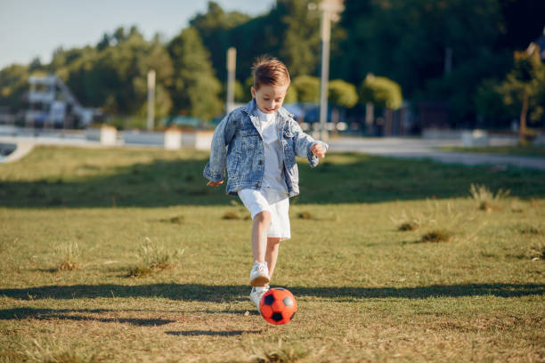 istock Cute little child playing in a summer park 1202355814