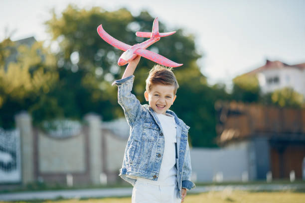 istock Cute little children playing in a summer park 1202356020