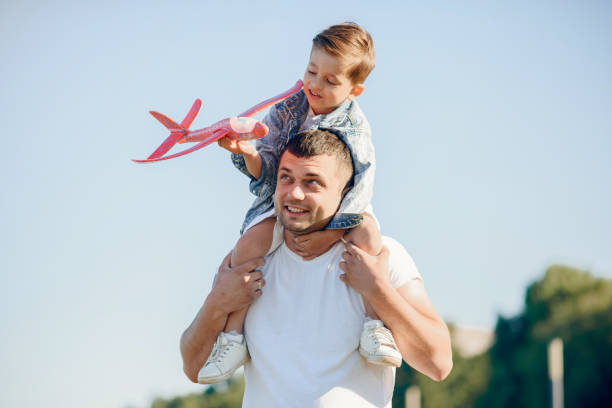 istock Cute family playing in a summer park 1202356111