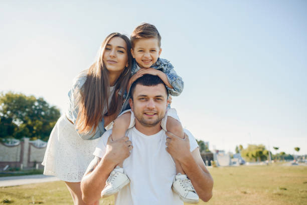 istock Cute family playing in a summer park 1202356216