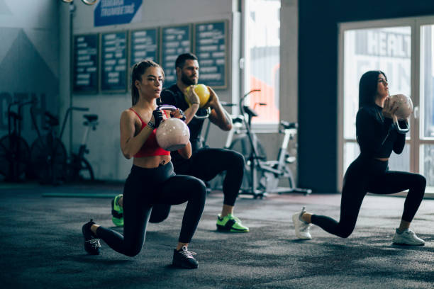 istock Small group of people working out in a gym 1202356332