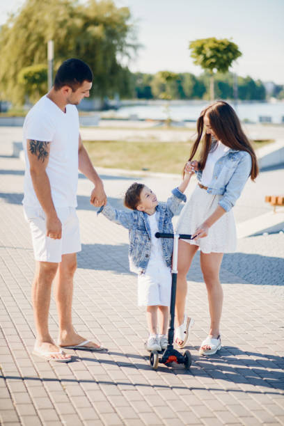 istock Cute family playing in a summer park 1202356397