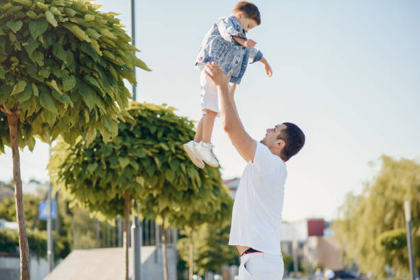istock Cute family playing in a summer park 1202356447