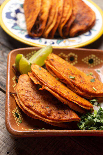 istock Mexican beef barbacoa tacos on wooden background 1202357707