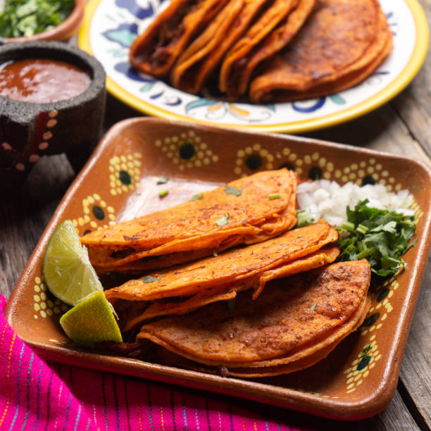 istock Mexican beef barbacoa tacos on wooden background 1202358736