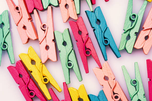 istock multicolored wooden clothespins on a white background 1202359311