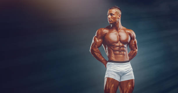 istock Strong, Muscular, Handsome Men Flexing Muscles. Bodybuilder Flexing Muscles. Copy Space 1202360625