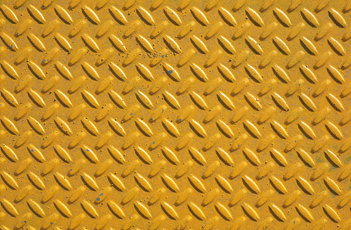 Yellow steel diamond plate useful as a background