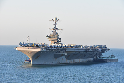 15th June, 2022.  Frigate warship sails into in the harbour port of Cartagena in Spain as the crew line up on the bow to see the view