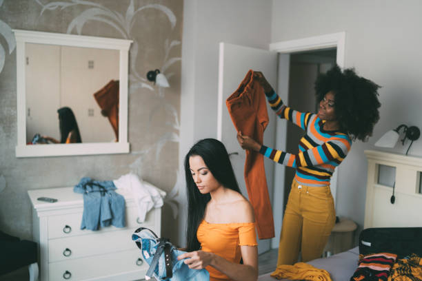 istock Female friends packing suicases for vacation 1202363576