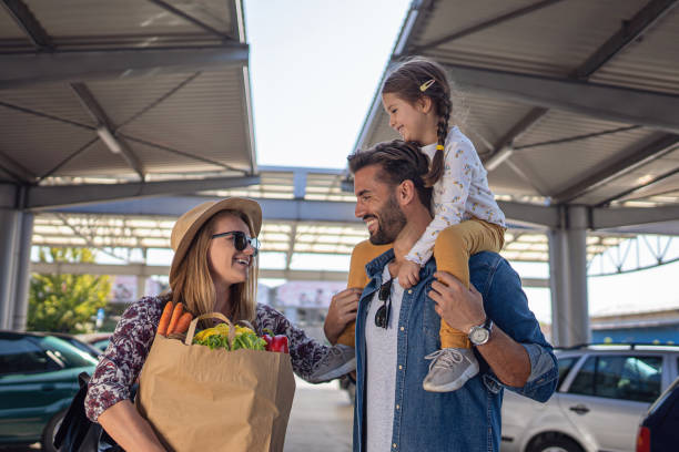 istock Beautiful young family returning from shopping 1202363721