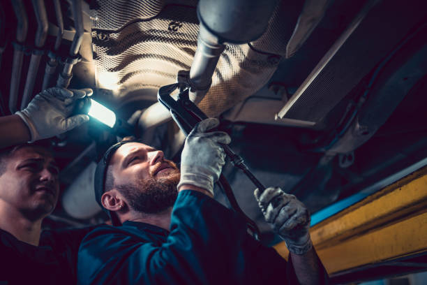 istock Two Mechanics Checking Car Exhaust System Pressure Valve 1202365505
