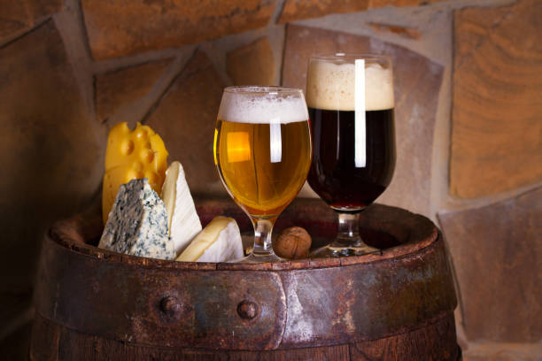 istock Light and dark beer accompanied with selection of cheeses 1202365592