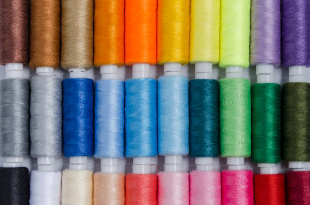 istock sewing threads different colors, very colorful in background, colorful background 1202367085