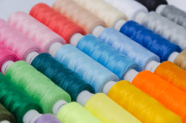 istock sewing threads different colors, very colorful in background, colorful background 1202367103