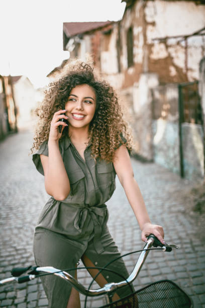 istock Cute Female Cyclist Enjoying Her Phone Call 1202367161