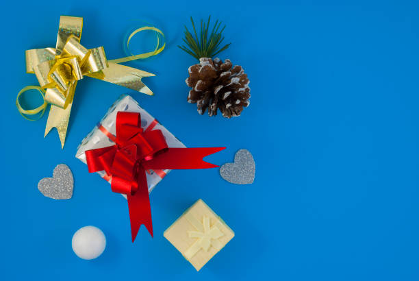 istock Christmas background with beautiful gift or present box, snowy pine cones and decorative snowballs, holiday. Top view 1202367493