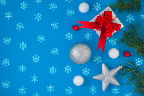 istock Christmas background with beautiful gift or present box, star and decorative snowball, holiday. Top view 1202368721