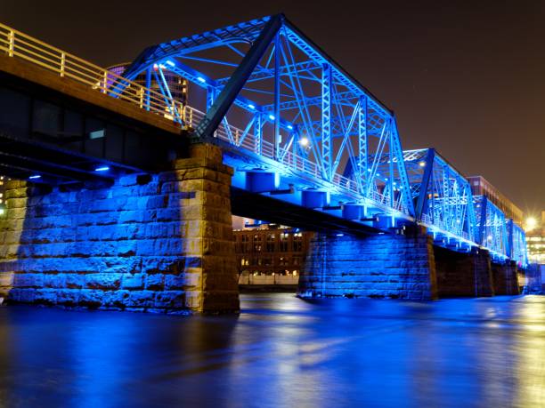 The glowing lights of a bridge reflect on the river water on a late summer evening in Toledo, Ohio.