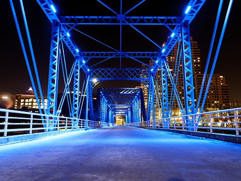 Long exposure of blue bridge lit up at night